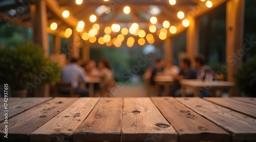 Rustic wooden table at a charming outdoor restaurant with friends dining under warm string lights, perfect for a summer evening gathering