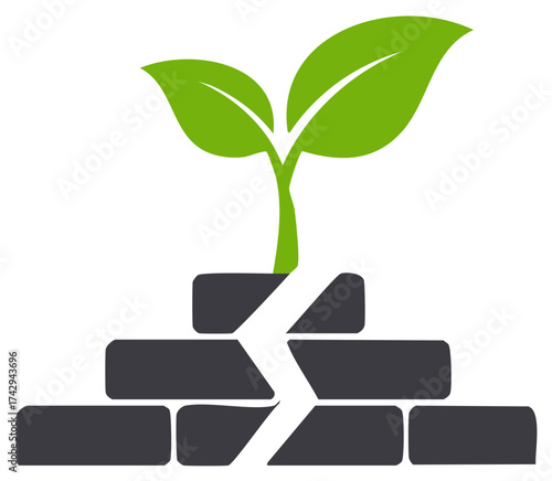 Plant seedling emerges from cracked brick wall representing resilience or environmental progress
