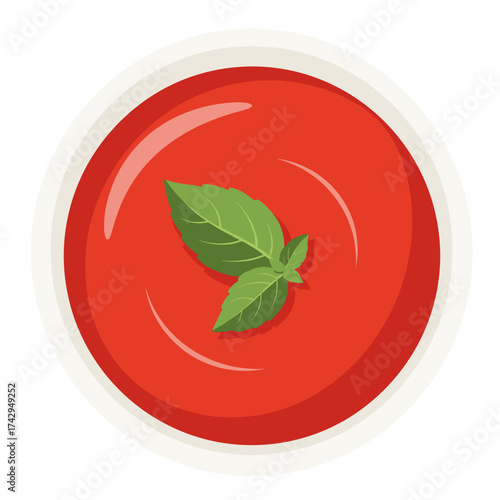 A bowl of rich tomato soup with fresh basil garnish.