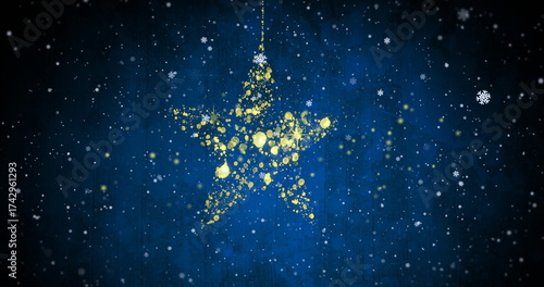 Golden star made of particles with falling snowflakes image on blue background