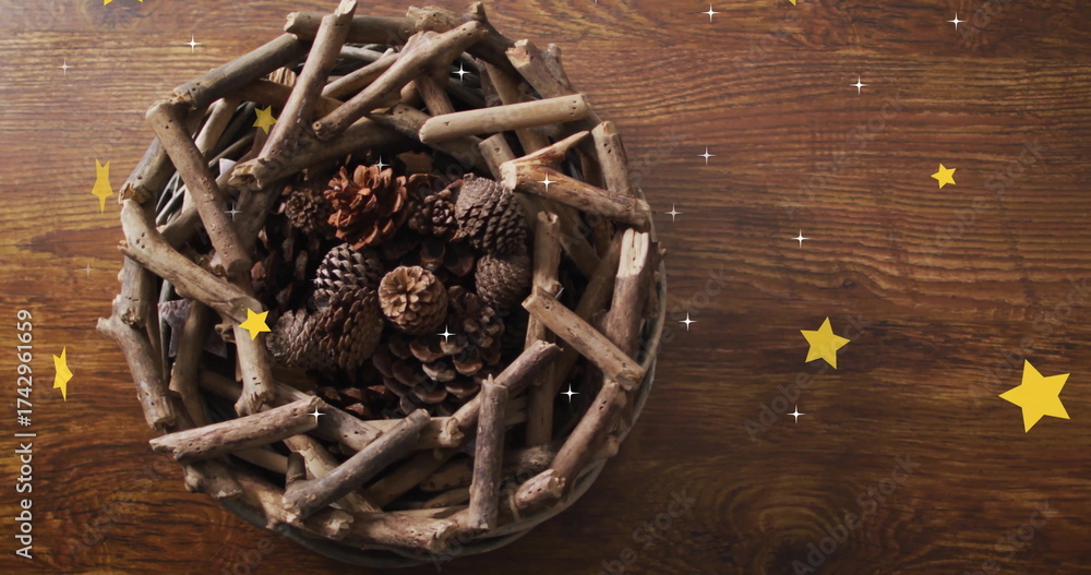 Naklejka premium Image of stars over wreath with branches and cones on wooden background