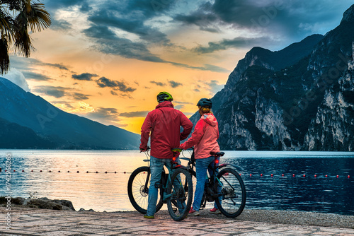 View of beautiful Lake Garda surrounded by mountains, Panoramic autumn view of sunset over Lake Garda in the evening with beautiful sunset colors, Italy