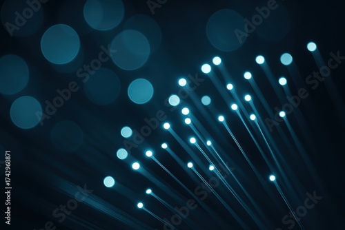 Glowing fiber optic strands with blue bokeh signals showing fast data transmission
