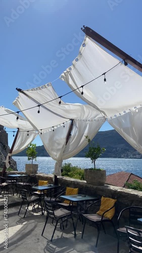 White fabric flowing in the wind at a seaside café