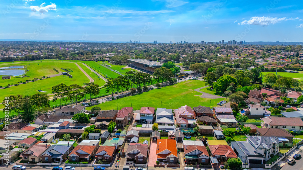 Obraz premium Aerial Drone view of Sydney Inner West Sydney Suburb of Ashbury and Croydon with house roof tops, the streets parks and cars in Sydney NSW Australia