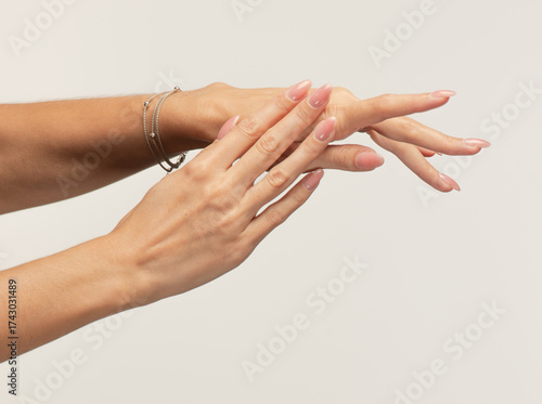 Fotografija women's palms rub cream and caress each other