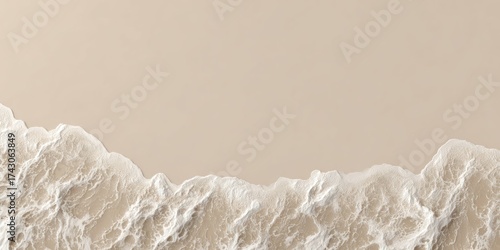 Aerial view of a beach light sand meets frothy, white surf. Soft color palette