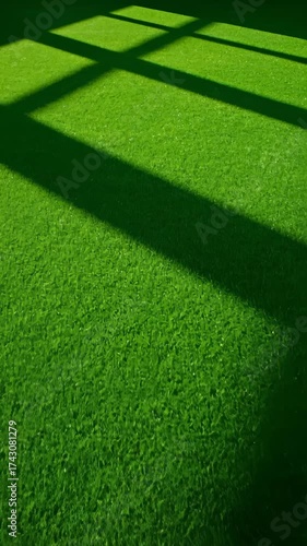 Vibrant Green Artificial Turf Surface With Dynamic Geometric Shadows Pattern