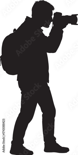 Silhouette of a person photographing with a camera and backpack