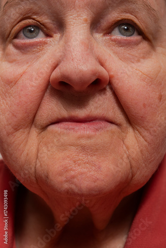 Old woman closeup portrait. Wrinkles. Facial skin problems. Blemishes and wrinkles on face. Flabby and wrinkled skin on senior woman face. Old woman face.