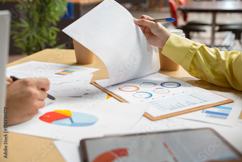 Business people, hands-on work, and people with documents in the office for data analysis. Financial analysts, teams, and documents for financial forecasting, budget planning, or strategy.