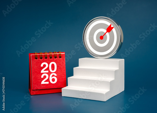 Bild auf Leinwand 2026 red table calendar with stairs leading to target board on blue background