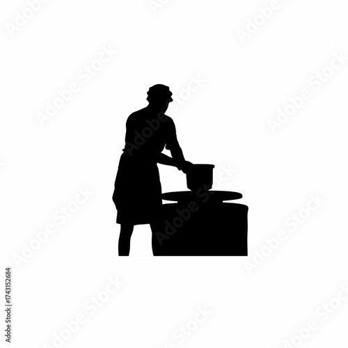 Silhouette of a potter shaping clay on a wheel isolated on white background