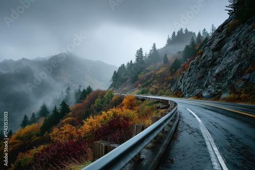 A curvy road cuts through misty mountains with autumnal colored foliage. Showcase travel, nature, and scenic drives during fall season easily.