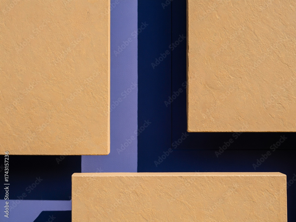 Fototapeta premium Textured Tan Rectangles Against Deep Blue Background