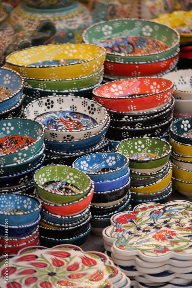 Naklejka premium Colorful handmade ceramic dishes at a market stall