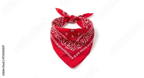 Red fabric accessory with a white and black paisley pattern folded and tied presented against a clean white background