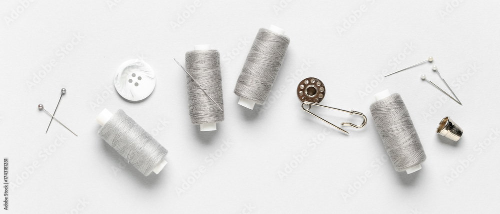 Fototapeta premium Sewing supplies on light background, top view