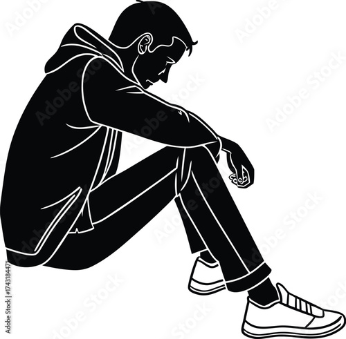 Sad young man sitting alone in silhouette