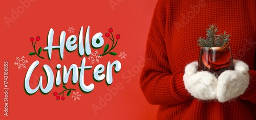 Woman in warm mittens holdi...