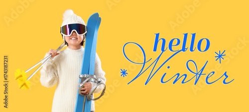 Little girl with skis on ye...
