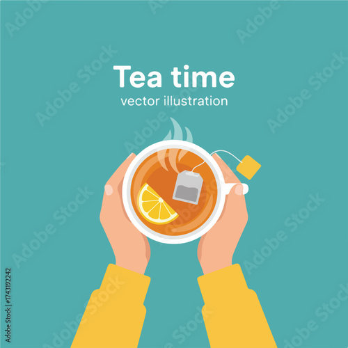 Top view of hands holding a cup of tea with lemon and tea bag