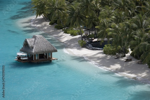 Turquoise lagoon with overwater hut, white sand beach, and palm trees