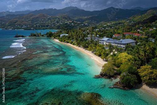 Aerial view of a tropical coastline with a pristine beach, lush vegetation, and turquoise waters