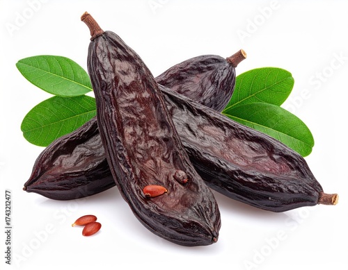 Wallpaper Mural Shiny carob pods and green leaves on a white surface Torontodigital.ca