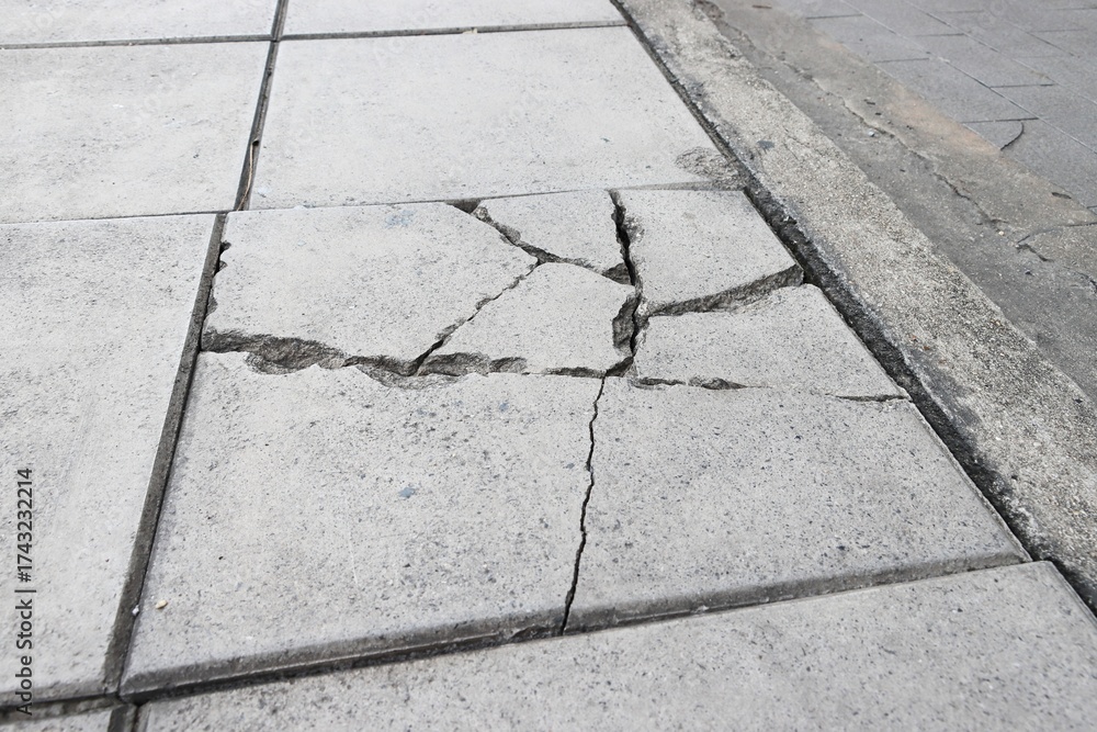 Fototapeta premium Broken sidewalk concrete block texture background