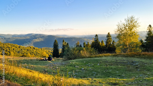 Biker relaxing on a meadow in Beskids.
