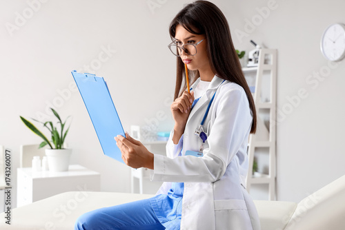 Thoughtful female doctor wi...