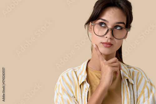 Thoughtful young woman in e...