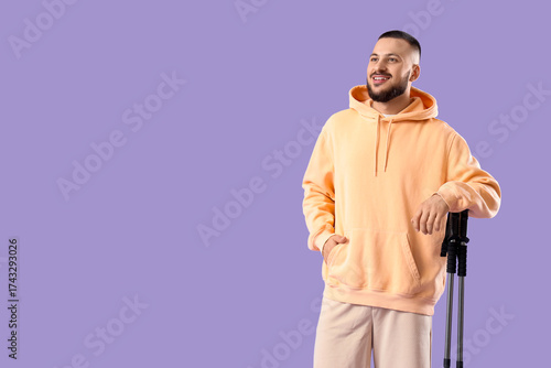 Smiling young man in peach ...