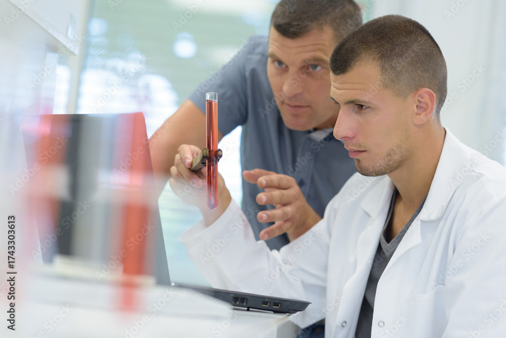 Obraz premium doctor with apprentice working in laboratory