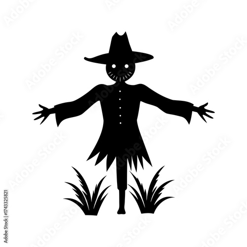 Black silhouette of a scarecrow standing in a field