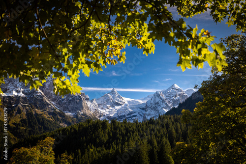 Glacier of Rosenlauigletscher and peaks of Tossen and Wetterhorn in autumn with fresh snow in Reichenbach Valley in Berner Oberland