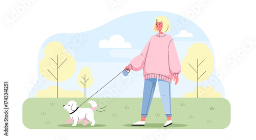 Woman enjoying leisure time walking her adorable puppy dog in the park on a beautiful day perfect