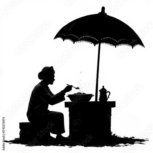 Silhouette Street Vendor: A striking silhouette captures a street vendor preparing food beneath the shade of an umbrella, offering a glimpse into everyday life.