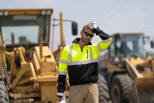 Builder construction man. Worker supervisor heavy machinery. Safety inspection. Industry construction worker. Builder civil engineer at building. Heavy work. Worker at construction site