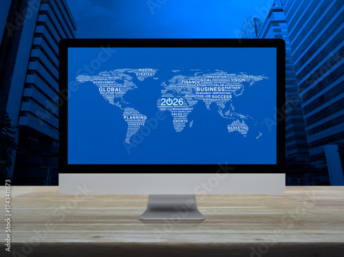 Fototapeta Naklejka Na Ścianę i Meble -  Start up 2026 business icon with global words world map on computer screen on table over city tower, Happy new year 2026 global business start up online, Elements of this image furnished by NASA