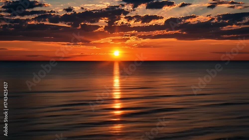 Stunning Sunset Over Calm Ocean Waters with Reflection and Dramatic Cloudscape in Tranquil Atmosphere