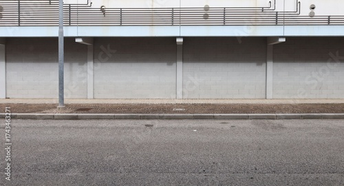 Wallpaper Mural Cinder blocks wall at the roadside. methan gas pipes of the first floor above. Sidewalk and street in front. Urban background for copy space. Torontodigital.ca