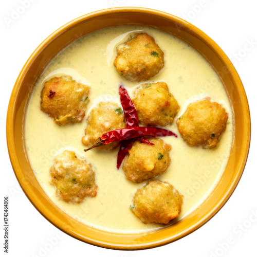 Gourmet Kadhi Pakora Indian Curry in a Yellow Bowl, Top-Down Flat Lay View