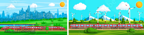 Red passenger train on railway tracks passing through a green landscape with city skyline and wind turbines. Urban transport and sustainable energy concept.