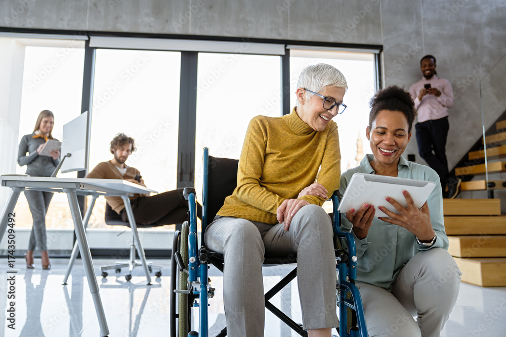 Obraz premium A diverse group of young professionals, including senior businesswomen entrepreneur in a wheelchair
