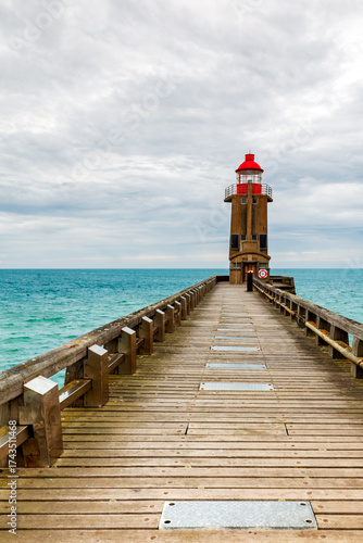 The Red Lighthouse at the end of the north dike of the port of Fecamp, alabaster coast, department of Seine Maritime, Normandie region, France. Portrait orientation.