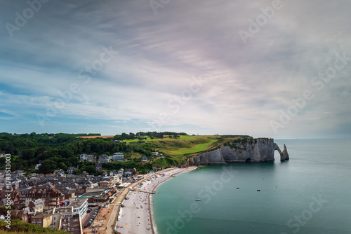The beach of Etretat and the Porte d’Aval Cliff, natural rock arch of the alabaster coast, department of Seine Maritime, Normandie region, France.