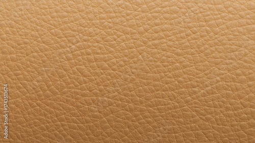 Close up textured background of natural light brown leather with subtle color variations and a soft matte finish