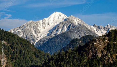 Majestic mountain peak reaching skyward under bright daylight